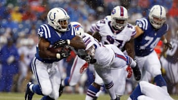 Aug 13, 2016; Orchard Park, NY, USA; Indianapolis Colts running back Josh Ferguson (34) runs with the ball as Buffalo Bills defensive end Jerry Hughes (55) dives to make a tackle during the first quarter at Ralph Wilson Stadium. Mandatory Credit: Kevin Hoffman-USA TODAY Sports