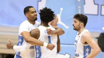 Jan 12, 2021; Chapel Hill, North Carolina, USA; North Carolina Tar Heels forward Garrison Brooks (15) reacts with guard Leaky Black (1) and guard Andrew Platek (3) after the game at Dean E. Smith Center. Mandatory Credit: Bob Donnan-USA TODAY Sports