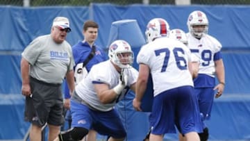 Jun 18, 2014; Buffalo, NY, USA; Buffalo Bills offensive lineman Kraig Urbik (60) performs a drill against center Macky MacPherson (76) during the Bills Minicamp at Ralph Wilson Stadium. Mandatory Credit: Kevin Hoffman-USA TODAY Sports