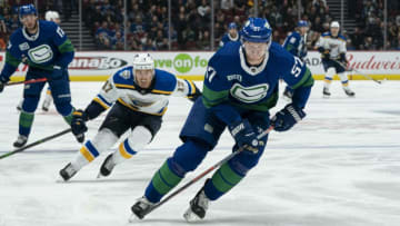 VANCOUVER, BC - NOVEMBER 05: Tyler Myers #57 of the Vancouver Canucks picks up the loose puck while pressured by Jaden Schwartz #17 of the St. Louis Blues at Rogers Arena on November 5, 2019 in Vancouver, Canada. (Photo by Rich Lam/Getty Images)