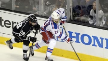 Jun 13, 2014; Los Angeles, CA, USA; New York Rangers center Derek Stepan (21) battles for the puck with Los Angeles Kings center Jarret Stoll (28) during the first period in game five of the 2014 Stanley Cup Final at Staples Center. Mandatory Credit: Richard Mackson-USA TODAY Sports