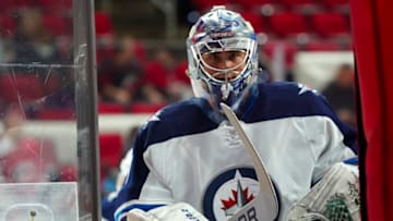 Apr 21, 2022; Raleigh, North Carolina, USA; Winnipeg Jets goaltender Eric Comrie (1) comes off the ice against the Carolina Hurricanes before the game at PNC Arena. Mandatory Credit: James Guillory-USA TODAY Sports
