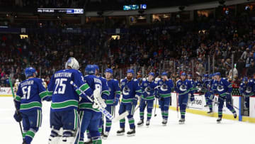 Jacob Markstrom #25 of the Vancouver Canucks is congratulated by teammates after their win against the Pittsburgh Penguins at Rogers Arena December 21, 2019 in Vancouver, British Columbia, Canada. Vancouver won 4-1. (Photo by Jeff Vinnick/NHLI via Getty Images)