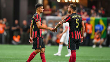 ATLANTA, GA AUGUST 27: Atlanta's Miles Robinson (12) slaps five with Leandro González Pirez (5) during the US Open Cup final match between Minnesota United FC and Atlanta United FC on August 27th, 2019 at Mercedes-Benz Stadium in Atlanta, GA. (Photo by Rich von Biberstein/Icon Sportswire via Getty Images)