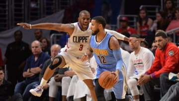 Mar 27, 2016; Los Angeles, CA, USA; Denver Nuggets guard D.J. Augustin (12) is defended by Los Angeles Clippers guard Chris Paul (3) during the second half at Staples Center. The Clippers defeated the Nuggets 105-90. Mandatory Credit: Kirby Lee-USA TODAY Sports