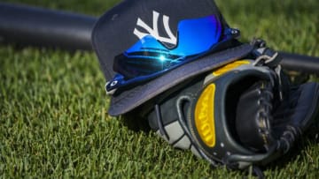 BALTIMORE, MD - JULY 10: The hat, sunglasses, glove and bat of New York Yankees center fielder Aaron Hicks (31) sits on the field prior to the game between the New York Yankees and the Baltimore Orioles on July 10, 2018, at Orioles Park at Camden Yards in Baltimore, MD. (Photo by Mark Goldman/Icon Sportswire via Getty Images)
