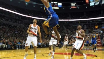Oct 19, 2012; Portland, OR, USA;Golden State Warriors shooting guard Brandon Rush (4) dunks the ball on Portland Trail Blazers power forward Joel Freeland (19) in the first quarter of the game at the Rose Garden. Mandatory Credit: Steve Dykes-US