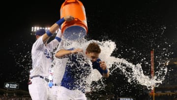 LOS ANGELES, CALIFORNIA - JUNE 01: Will Smith #16 of the Los Angeles Dodgers is doused with a bucket of water by teammates Cody Bellinger #35 and Joc Pederson #31 after Smith hit a walk-off homerun in the ninth inning of the MLB game against the Philadelphia Phillies at Dodger Stadium on June 01, 2019 in Los Angeles, California. The Dodgers defeated the Phillies 4-3. (Photo by Victor Decolongon/Getty Images)