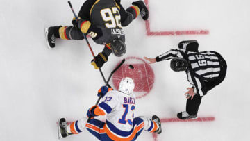 LAS VEGAS, NV - DECEMBER 20: Paul Stastny #26 of the Vegas Golden Knights faces off with Mathew Barzal #13 of the New York Islanders during a game at T-Mobile Arena on December 20, 2018 in Las Vegas, Nevada. (Photo by Jeff Bottari/NHLI via Getty Images)