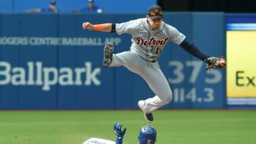 Aug 29, 2015; Toronto, Ontario, CAN; Detroit Tigers shortstop Jose Iglesias (1) leaps over Toronto Blue Jays third baseman Josh Donaldson (20) during the sixth inning at Rogers Centre. Mandatory Credit: Dan Hamilton-USA TODAY Sports