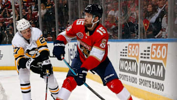 SUNRISE, FL - FEBRUARY 7: Riley Sheahan #15 of the Florida Panthers looks to pass against Nick Bjugstad #27 of the Pittsburgh Penguins at the BB&T Center on February 7, 2019 in Sunrise, Florida. (Photo by Eliot J. Schechter/NHLI via Getty Images)