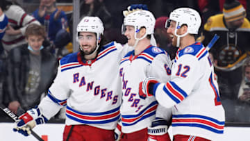 Nov 26, 2021; Boston, Massachusetts, USA; New York Rangers defenseman Jacob Trouba (8) is congratulated by center Mika Zibanejad (93) and defenseman Patrik Nemeth (12) after scoring an empty net goal during the third period against the Boston Bruins at TD Garden. Mandatory Credit: Bob DeChiara-USA TODAY Sports