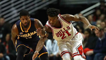 CHICAGO, IL - DECEMBER 26: Jimmy Butler #21 of the Chicago Bulls and Paul George #13 of the Indiana Pacers chase down a loose ball at the United Center on December 26, 2016 in Chicago, Illinois. (Photo by Jonathan Daniel/Getty Images)