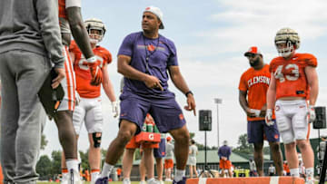 Clemson offensive coordinator Tony Elliott talks with tight ends during practice on Aug. 12.Clemson Football Practice August 12