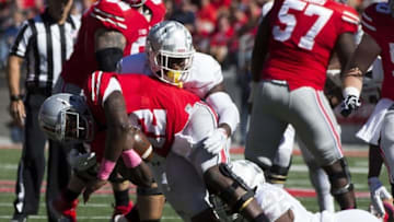 Oct 10, 2015; Columbus, OH, USA;Ohio State Buckeyes quarterback Cardale Jones (12) is sacked by Maryland Terrapins defensive linemen Yannick Ngakoue (7) and Azubuike Ukandu (95) at Ohio Stadium. Mandatory Credit: Greg Bartram-USA TODAY Sports