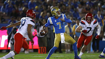 PASADENA, CA - OCTOBER 20: Quarterback Dorian Thompson-Robinson #7 of the UCLA Bruins passes the ball while under pressure from safety Scottie Young Jr. #19 and linebacker Colin Schooler #7 of the Arizona Wildcats during the first half of the NCAA college football game against the Arizona Wildcats at the Rose Bowl on October 20, 2018 in Pasadena, California. (Photo by Victor Decolongon/Getty Images)