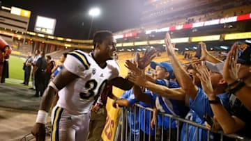 Sep 25, 2014; Tempe, AZ, USA; UCLA Bruins linebacker Myles Jack (30) celebrates with fans following the game against the Arizona State Sun Devils at Sun Devil Stadium. UCLA defeated Arizona State 62-27. Mandatory Credit: Mark J. Rebilas-USA TODAY Sports