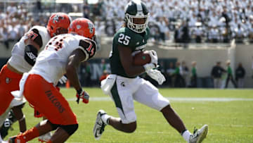 EAST LANSING, MI - SEPTEMBER 02: Darrell Stewart Jr. #25 of the Michigan State Spartans looks to get around the tackle of Marcus Milton #14 of the Bowling Green Falcons during the first half at Spartan Stadium on September 2, 2017 in East Lansing, Michigan. (Photo by Gregory Shamus/Getty Images)