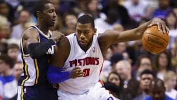 Jan 17, 2014; Auburn Hills, MI, USA; Detroit Pistons power forward Greg Monroe (10) is defended by Utah Jazz small forward Jeremy Evans (40) in the first half at The Palace of Auburn Hills. Utah won 110-89. Mandatory Credit: Rick Osentoski-USA TODAY Sports
