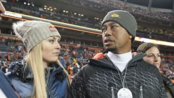 Nov 17, 2013; Denver, CO, USA; American golfer Tiger Woods with girlfriend American skier Lindsey Vonn on the sidelines before the game between the Kansas City Chiefs and the Denver Broncos at Sports Authority Field at Mile High. Mandatory Credit: Ron Chenoy-USA TODAY Sports