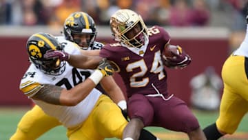 MINNEAPOLIS, MN - OCTOBER 06: A.J. Epenesa #94 of the Iowa Hawkeyes tackles Mohamed Ibrahim #24 of the Minnesota Golden Gophers during the first quarter of the game on October 6, 2018 at TCF Bank Stadium in Minneapolis, Minnesota. (Photo by Hannah Foslien/Getty Images)