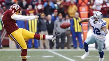 Dec 28, 2014; Landover, MD, USA; Washington Redskins punter Tress Way (5) kicks the ball in front of Dallas Cowboys cornerback Orlando Scandrick (32) in the first quarter at FedEx Field. Mandatory Credit: Geoff Burke-USA TODAY Sports