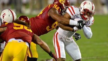 Dec 27, 2014; San Diego, CA, USA; Nebraska Cornhuskers running back Ameer Abdullah (8) carries the ball as USC Trojans defensive end Leonard Williams (94) defends during the first quarter in the 2014 Holiday Bowl at Qualcomm Stadium. Mandatory Credit: Jake Roth-USA TODAY Sports