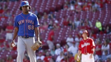 Sep 7, 2014; Cincinnati, OH, USA; New York Mets relief pitcher Jenrry Mejia (58) waits at the mound during a replay review in the ninth inning at Great American Ball Park. Cincinnati Reds third baseman Todd Frazier waits at first base at right. The Mets won 4-3. Mandatory Credit: David Kohl-USA TODAY Sports