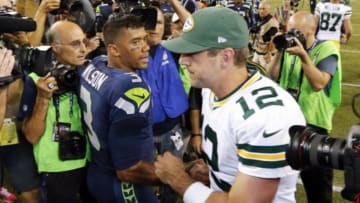 Sep 4, 2014; Seattle, WA, USA; Green Bay Packers quarterback Aaron Rodgers (12) shakes hands with Seattle Seahawks quarterback Russell Wilson (3) following a 36-16 Seahawks victory at CenturyLink Field. Mandatory Credit: Joe Nicholson-USA TODAY Sports