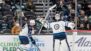 Dec 9, 2021; Seattle, Washington, USA; Winnipeg Jets goalkeeper Connor Hellebuyck (37) celebrates as time expires during the third period against the Seattle Kraken at Climate Pledge Arena. Mandatory Credit: Stephen Brashear-USA TODAY Sports