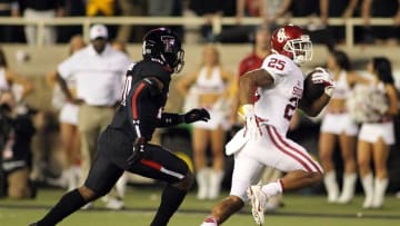 Oct 22, 2016; Lubbock, TX, USA; Oklahoma Sooners running back Joe Mixon (25) rushes against Texas Tech Red Raiders defensive back Jordyn Brooks (20) in the first half at Jones AT&T Stadium. Mandatory Credit: Michael C. Johnson-USA TODAY Sports
