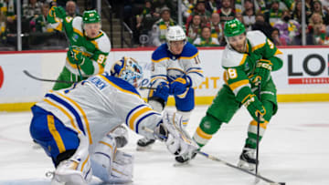 Jan 28, 2023; Saint Paul, Minnesota, USA; Buffalo Sabres goaltender Ukko-Pekka Luukkonen (1) pokes the puck away from Minnesota Wild right wing Ryan Hartman (38) in the second period at Xcel Energy Center. Mandatory Credit: Matt Blewett-USA TODAY Sports