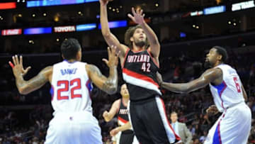 October 24, 2014; Los Angeles, CA, USA; Portland Trail Blazers center Robin Lopez (42) shoots against the defense of Los Angeles Clippers forward Matt Barnes (22) and center DeAndre Jordan (6) during the first half at Staples Center. Mandatory Credit: Gary A. Vasquez-USA TODAY Sports