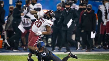 Dec 5, 2020; Lexington, Kentucky, USA; South Carolina Gamecocks running back Kevin Harris (20) is tackled by Kentucky Wildcats defensive back Brandin Echols (26) during the third quarter at Kroger Field. Mandatory Credit: Arden Barnes-USA TODAY Sports