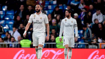 Real Madrid's French forward Karim Benzema and Real Madrid's Spanish defender Sergio Ramos (R) react after Huesca's second goal during the Spanish League football match between Real Madrid CF and SD Huesca at the Santiago Bernabeu stadium in Madrid on March 31, 2019. (Photo by JAVIER SORIANO / AFP) (Photo credit should read JAVIER SORIANO/AFP/Getty Images)