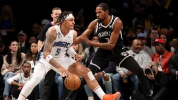 Nov 28, 2022; Brooklyn, New York, USA; Orlando Magic forward Paolo Banchero (5) controls the ball against Brooklyn Nets forward Kevin Durant (7) during the third quarter at Barclays Center. Mandatory Credit: Brad Penner-USA TODAY Sports