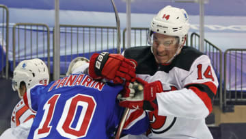 New Jersey Devils right wing Nathan Bastian (14) grabs a hold of New York Rangers left wing Artemi Panarin (10) during the second period at Madison Square Garden. Mandatory Credit: Bruce Bennett/Pool Photos-USA TODAY Sports