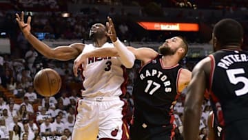 May 7, 2016; Miami, FL, USA; Miami Heat guard Dwyane Wade (3) is fouled by Toronto Raptors center Jonas Valanciunas (17) during the third quarter in game three of the second round of the NBA Playoffs at American Airlines Arena. Mandatory Credit: Steve Mitchell-USA TODAY Sports