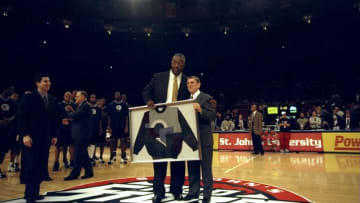 Former St. John's basketball head coach Lou Carnesecca presents John Thompson with an award.