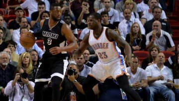 Jan 20, 2015; Miami, FL, USA; Miami Heat guard Dwyane Wade (3) is pressured by Oklahoma City Thunder guard Dion Waiters (23) during the first half at American Airlines Arena. Mandatory Credit: Steve Mitchell-USA TODAY Sports