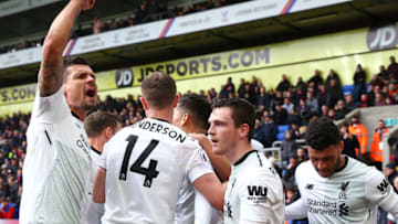 LONDON, ENGLAND - MARCH 31: Dejan Lovren of Liverpool , Jordan Henderson of Liverpool, Andy Robertson of Liverpool and Alex Oxlade-Chamberlain of Liverpool celebrate with Mohamed Salah of Liverpool (obscured) after he scores his sides second goal during the Premier League match between Crystal Palace and Liverpool at Selhurst Park on March 31, 2018 in London, England. (Photo by Jordan Mansfield/Getty Images)