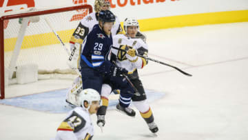 WINNIPEG, MB DECEMBER 01: Vegas Golden Knights forward Cody Eakin (21) jostles for position with Winnipeg Jets forward Patrik Laine (29) during the NHL game between the Winnipeg Jets and the Vegas Golden Knights on December 01, 2017 at the Bell MTS Place in Winnipeg MB. (Photo by Terrence Lee/Icon Sportswire via Getty Images)