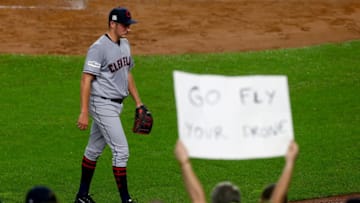 NEW YORK, NY - OCTOBER 09: Trevor Bauer #47 of the Cleveland Indians walks back to the dugout as a fan holds a sign that reads, "GO FLY YOUR DRONE" after being relieved during the second inning against the New York Yankees in Game Four of the American League Divisional Series at Yankee Stadium on October 9, 2017 in the Bronx borough of New York City. (Photo by Mike Stobe/Getty Images)