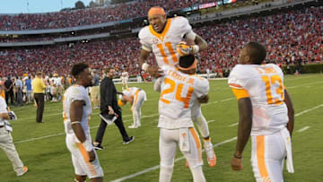 Oct 1, 2016; Athens, GA, USA; Tennessee Volunteers quarterback Joshua Dobbs (11) is lifted in the air by defensive back Todd Kelly Jr. (24) after throwing the winning touchdown pass on the last play on the game against the Georgia Bulldogs during the fourth quarter at Sanford Stadium. Tennessee defeated Georgia 34-31. Mandatory Credit: Dale Zanine-USA TODAY Sports