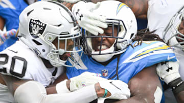 CARSON, CA - OCTOBER 07: Running back Melvin Gordon #28 of the Los Angeles Chargers is tackled by defensive back Obi Melifonwu #20 and linebacker Marquel Lee #55 of the Oakland Raiders in the third quarter at StubHub Center on October 7, 2018 in Carson, California. (Photo by Harry How/Getty Images)