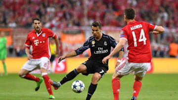 MUNICH, GERMANY - APRIL 12 : Javi Martinez (L) and Xabi Alonso (R) of Munich and Cristiano Ronaldo (C) of Madrid vie for the ball during the UEFA Champions League quarter final match between FC Bayern Munich and Real Madrid, at the Allianz Arena in Munich, Germany on April 12, 2017. (Photo by Lukas Barth/Anadolu Agency/Getty Images)