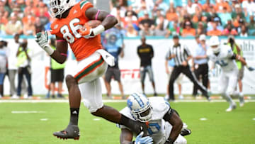 Oct 15, 2016; Miami Gardens, FL, USA; Miami Hurricanes tight end David Njoku (86) evades the tackle of North Carolina Tar Heels linebacker Andre Smith (10) during the first half at Hard Rock Stadium. Mandatory Credit: Jasen Vinlove-USA TODAY Sports