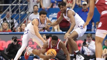 Indiana forward Jordan Geronimo (22) reaches for the ball against Kansas redshirt senior Kevin McCullar Jr. (15) and freshman forward Zuby Ejiofor (35) during the first quarter of Saturday's game inside Allen Fieldhouse.