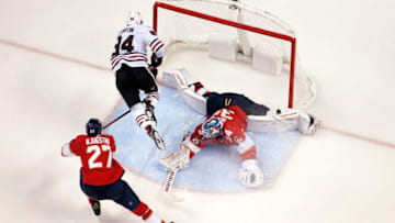 SUNRISE, FL - NOVEMBER 24: Alexandre Fortin #84 of the Chicago Blackhawks goes airborne and scores against Goaltender James Reimer #34 and Nick Bjugstad #27 of the Florida Panthers in the third period at the BB&T Center on November 24, 2018 in Sunrise, Florida. (Photo by Eliot J. Schechter/NHLI via Getty Images)