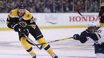 Nov 22, 2016; Boston, MA, USA; St. Louis Blues left wing David Perron (57) tries to prevent Boston Bruins center Dominic Moore (28) from collecting a loose puck during the second period at TD Garden. Mandatory Credit: Greg M. Cooper-USA TODAY Sports